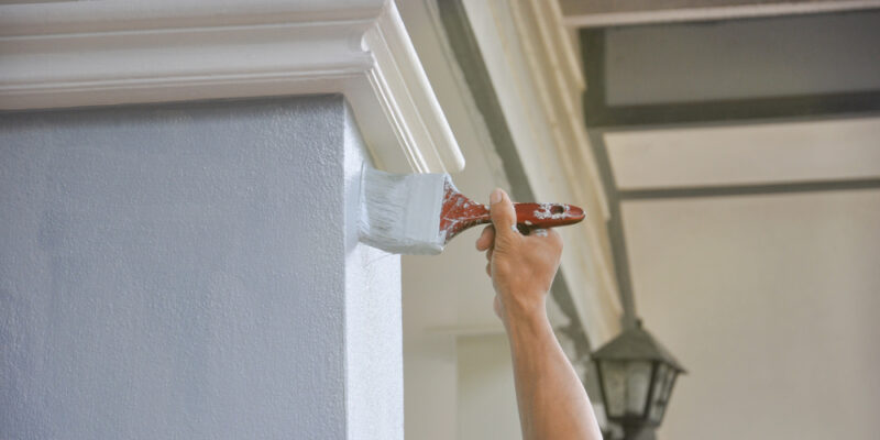 Man,Hand,Painted,A,House,Pillar,With,Brush