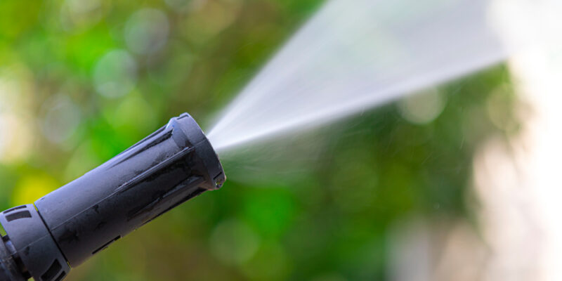 Close,Up,Of,High,Pressure,Water,Nozzle,On,Green,Nature