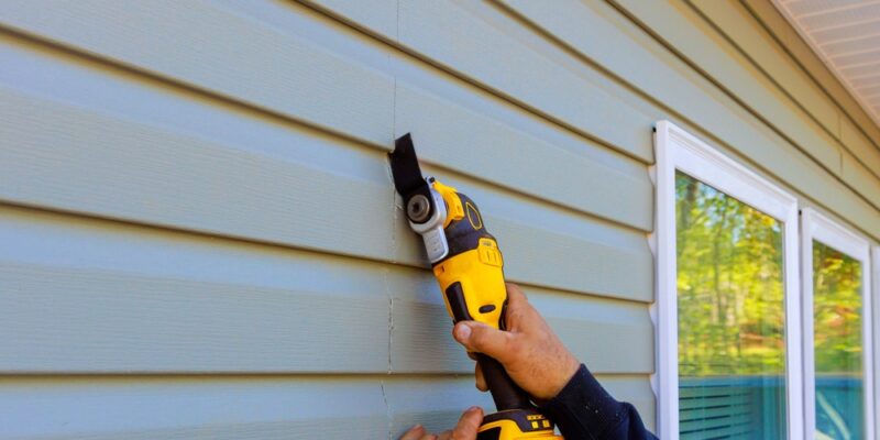 During,Reconstruction,Of,House,,Multi,Tools,Damaged,Vinyl,Siding,Is